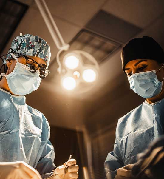 Surgeons performing a procedure in operating room.