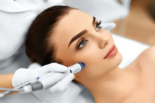 Woman receiving facial treatment in a clinic.