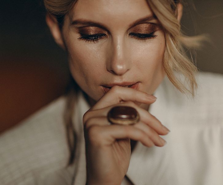 Woman thoughtfully resting her chin on hand.