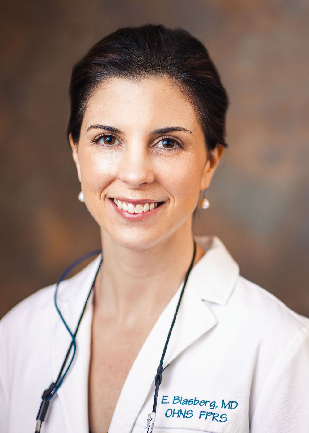 Female doctor smiling in a white coat.