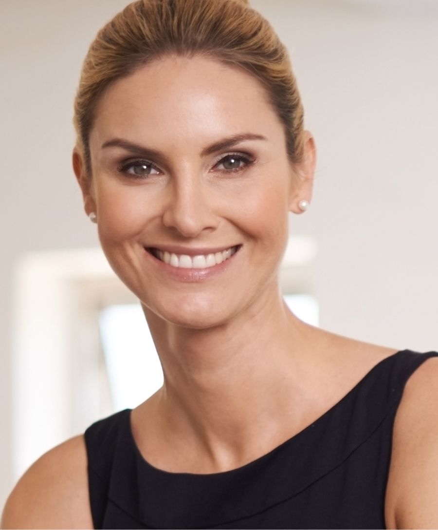 Smiling woman in a black sleeveless top.