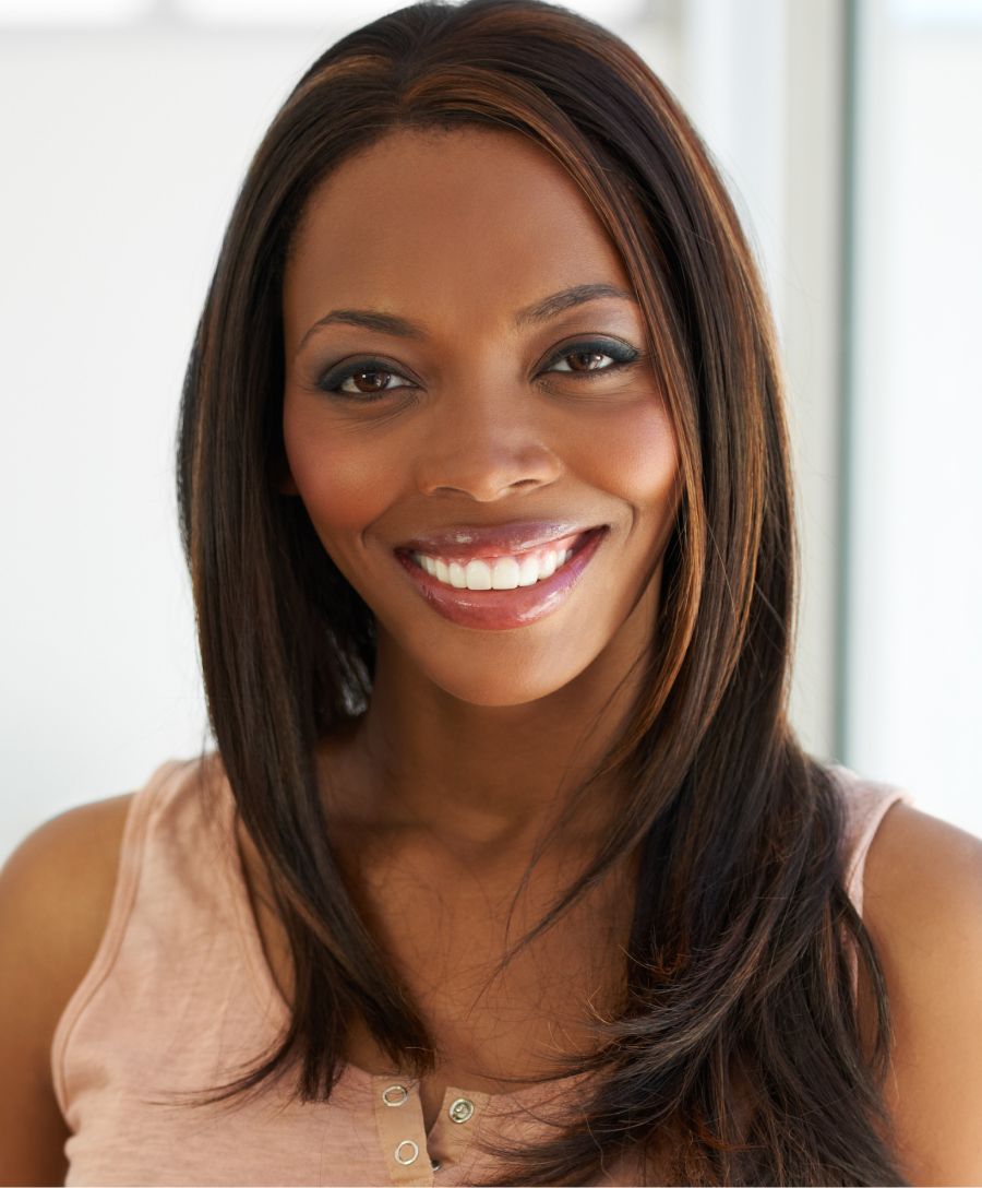 Smiling woman with blonde hair and cozy sweater