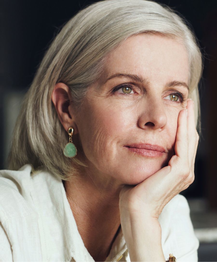 Smiling woman with blonde hair and cozy sweater