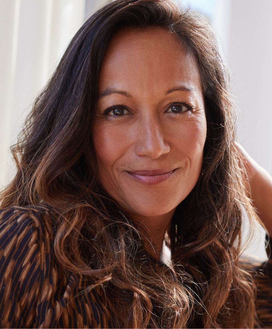 Smiling woman with blonde hair and blue eyes.