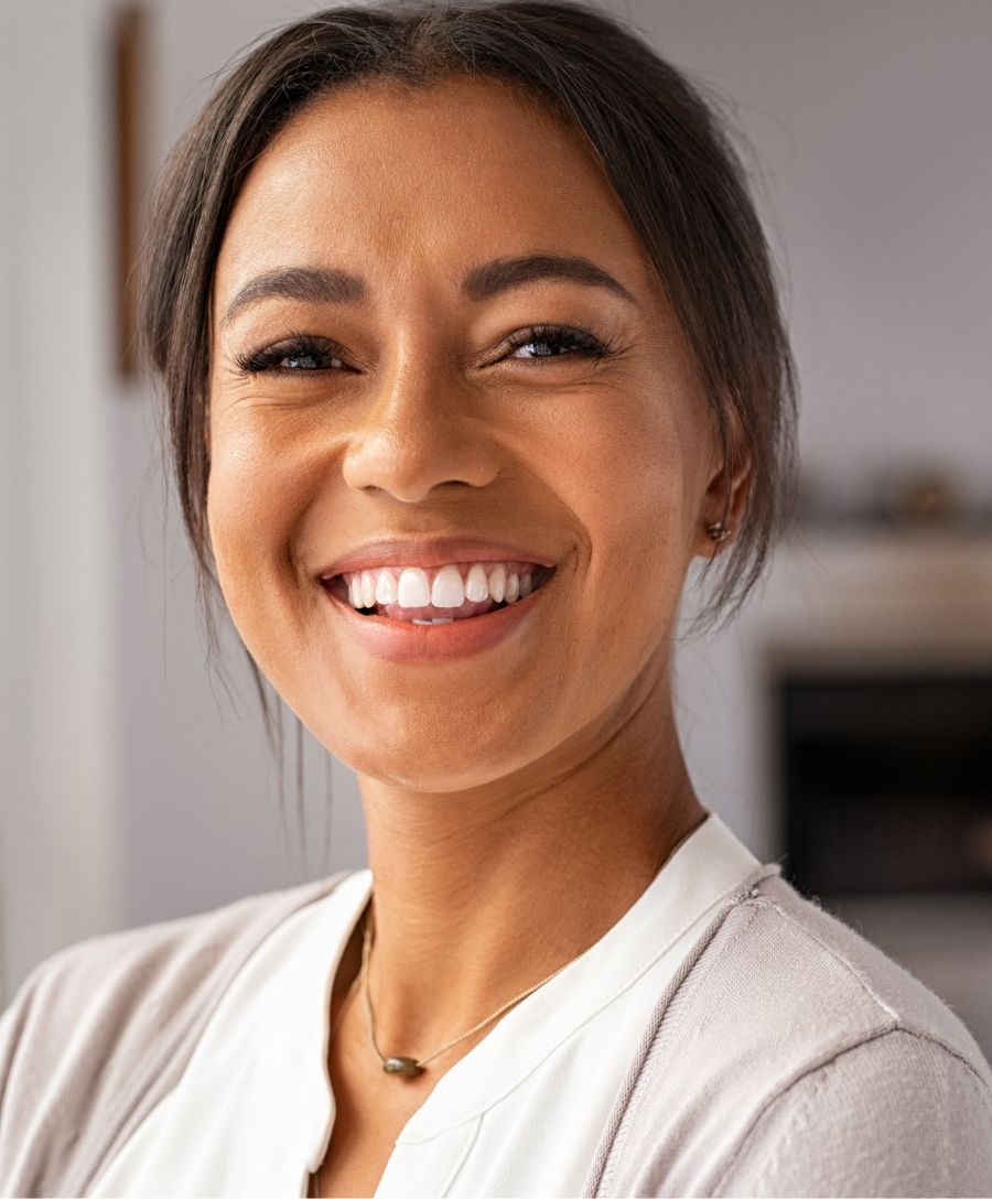 Smiling woman with blonde hair and cozy sweater