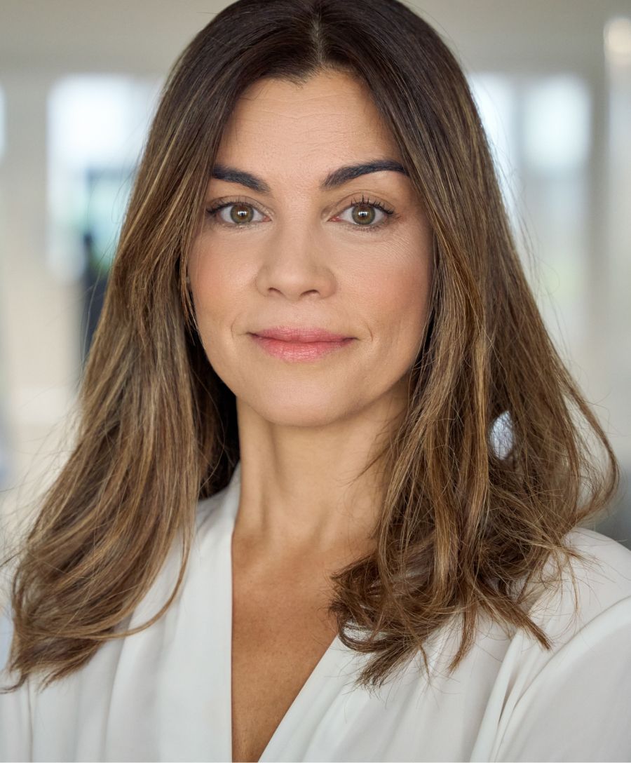 Dermatologist examining patient in consultation room.