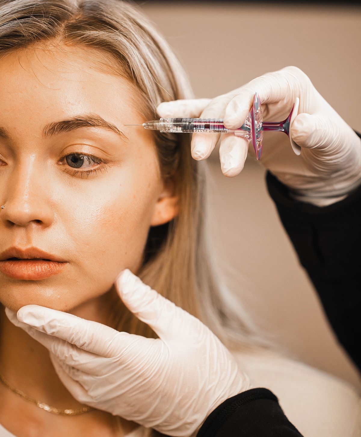 Woman receiving a cosmetic treatment in clinic.