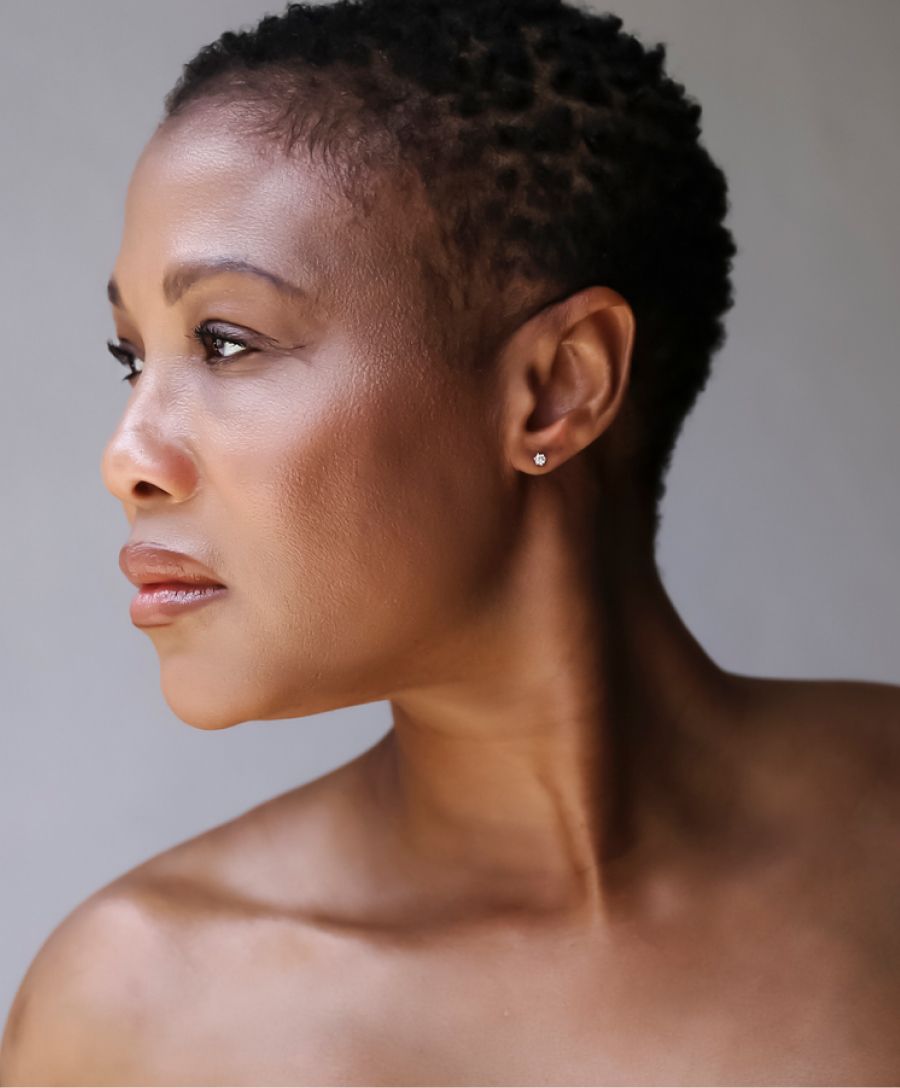 Profile of a woman with short, textured hair.