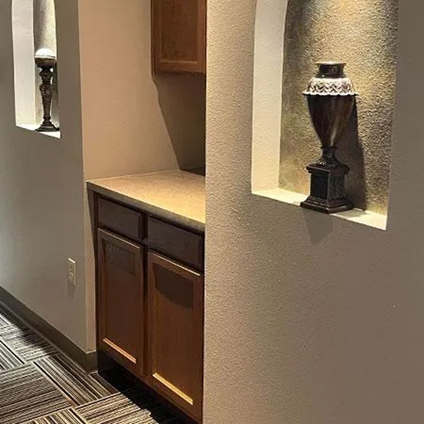 Interior hallway with decorative lighting and cabinetry.