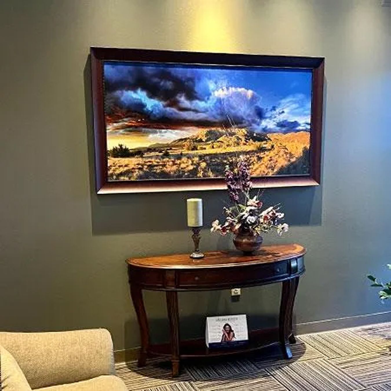 Art piece on wall with elegant table decor.