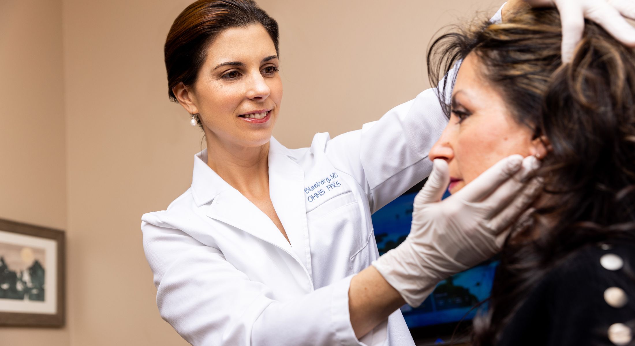 Doctor examining patient in medical consultation room.