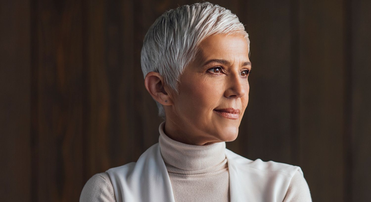Woman smiling with long, wavy hair.