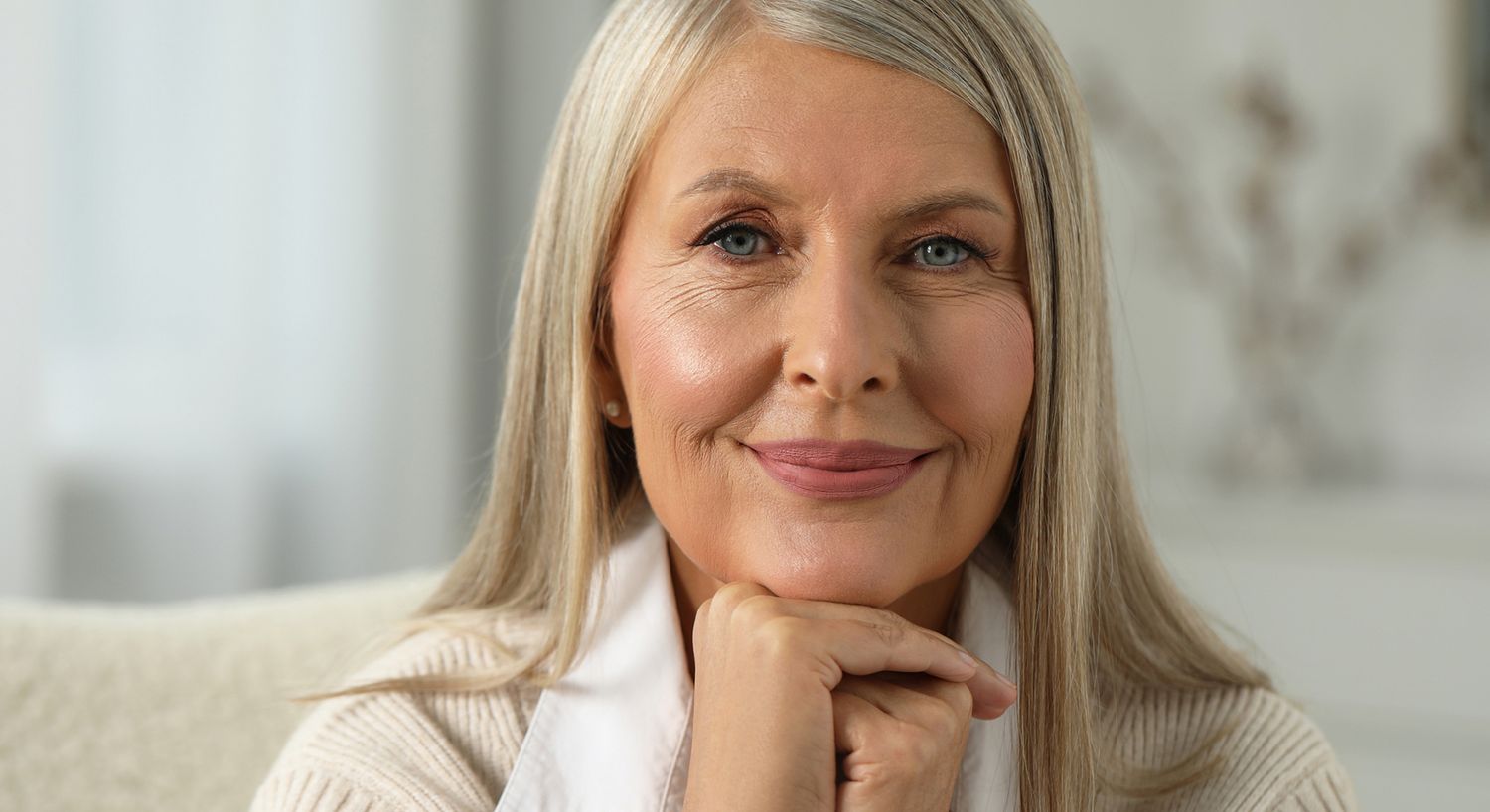 Smiling older woman with elegant hairstyle.