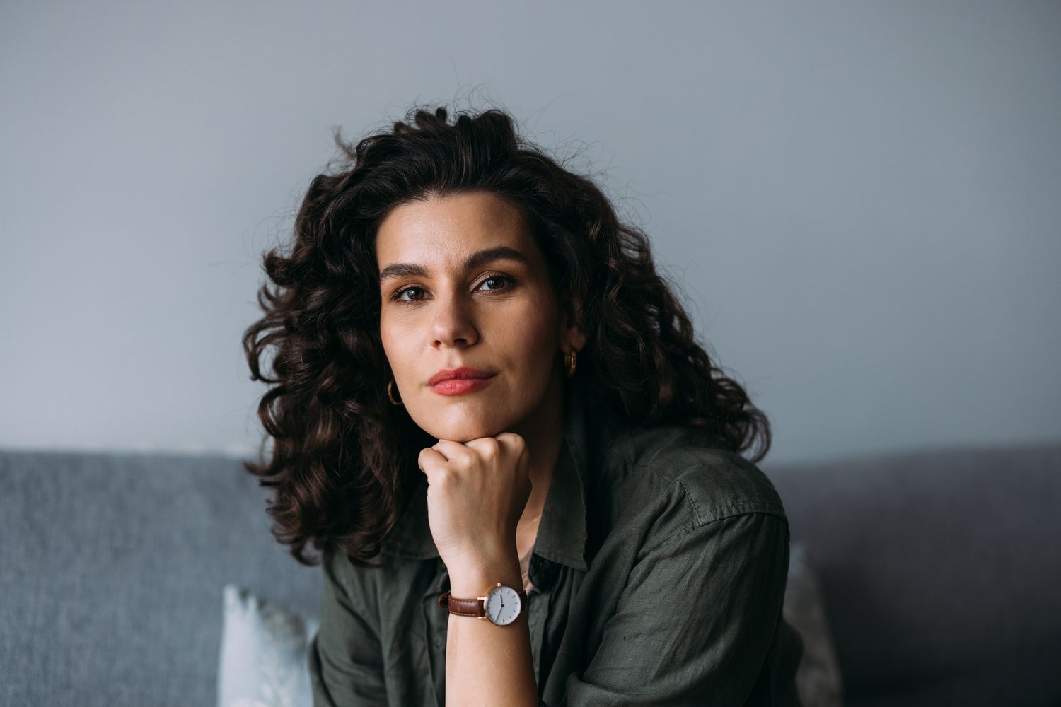 Smiling woman with light blonde hair indoors.