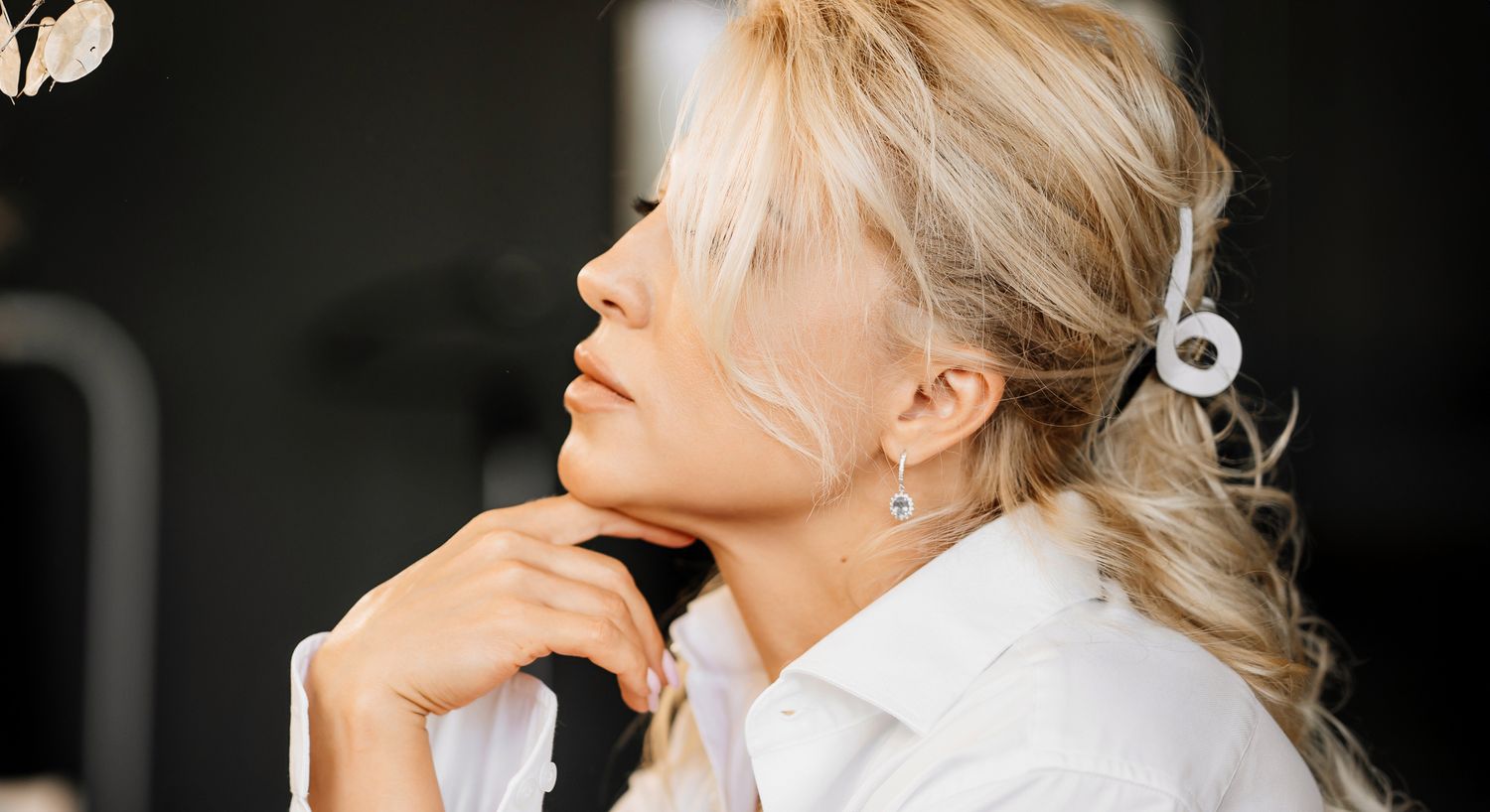 Smiling woman in a light blouse, indoors.